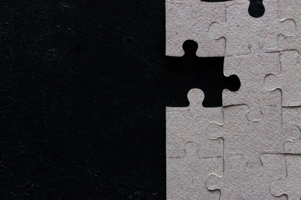 istock The last missing piece in a puzzle on a black background with space for text. 1062495198