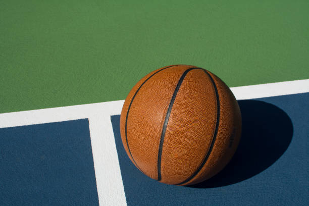istock Basketball sits on court 1062495698