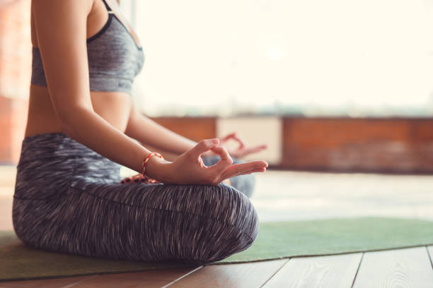 istock Young girl in a lotus position indoors 1062498144