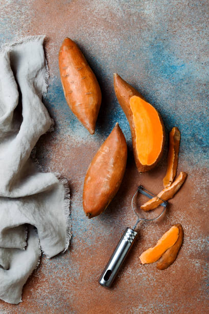 istock Sweet potato on rustic table. Cooking concept. Top view 1062498332