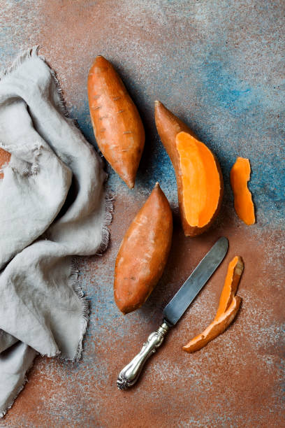 istock Sweet potato on rustic table. Cooking concept. Top view 1062498376