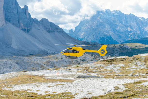 istock Yellow helicopter in flight, Dolomites, Italy 1062499126