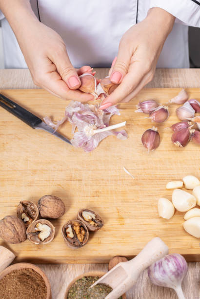 istock woman cook cleans garlic cloves 1062500268
