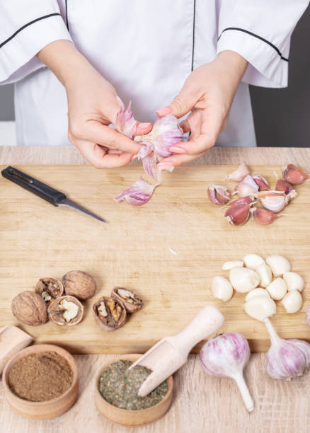 istock woman cook cleans garlic cloves 1062501418