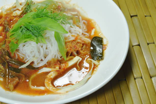istock Thai rice noodles dressing curry with fresh vegetable 1062501938