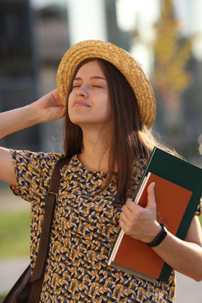 istock Young female student with backpack and books, outdors. Student. 1062501978