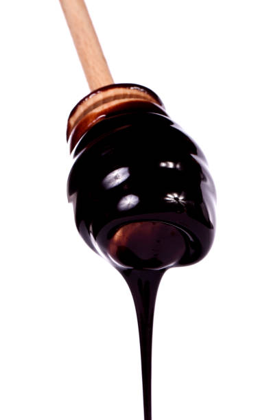 istock honey dipper with dark chocolate isolated 1062502038