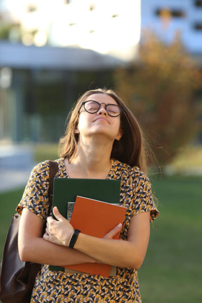istock Young female student with backpack and books, outdors. Student. 1062502068