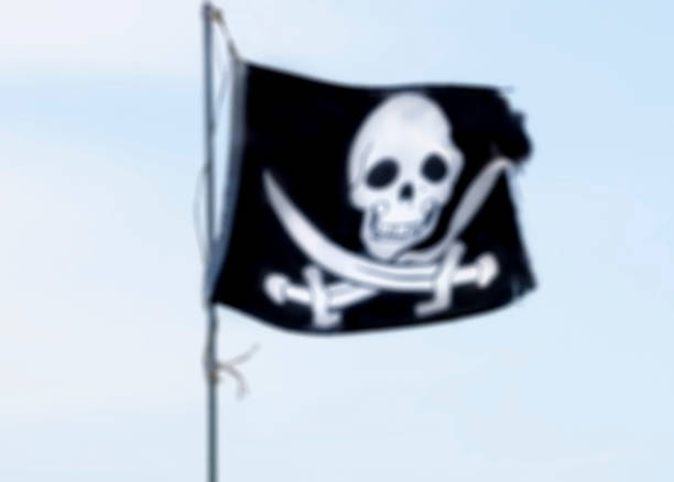 istock blurred background with Pirate flag against sky 1062504056