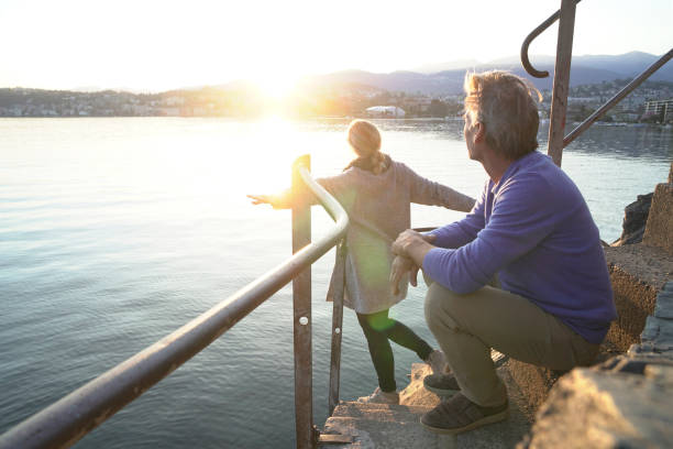 istock Couple look accross water to sunset 1062511070