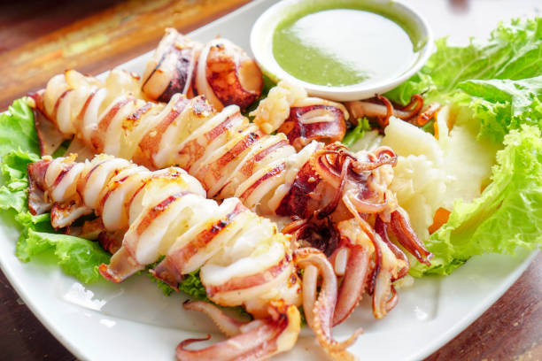 istock Slice of Grilled squid with Thai seafood sauce. 1062517452
