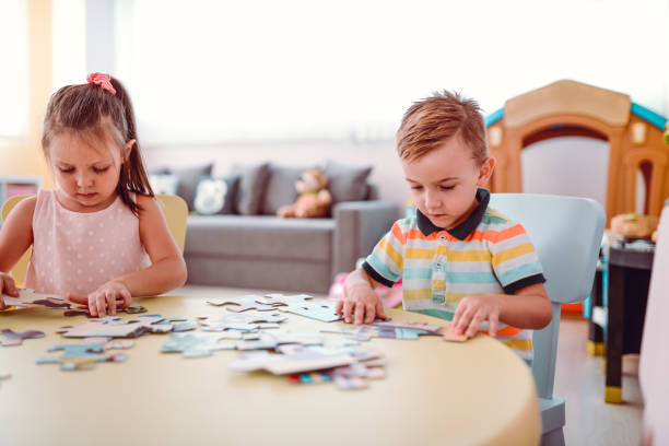istock Cute Kids Are Solving Puzzle In The Kinder Garden 1062517530