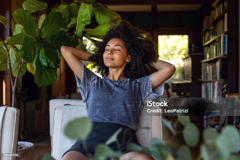 Young woman spending a relaxing day in her beautiful home Young american woman enjoy some time in her house in Los Angeles, California. Women Stock Photo