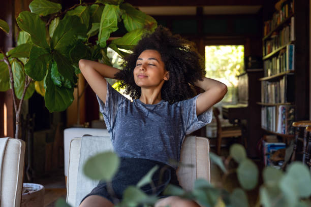 Young woman spending a relaxing day in her beautiful home Young american woman enjoy some time in her house in Los Angeles, California. woman emotion stock pictures, royalty-free photos & images