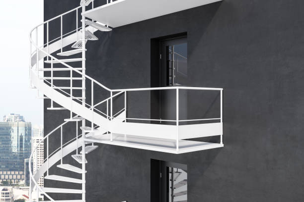 istock Gray building with white spiral fire escape stairs 1062518080