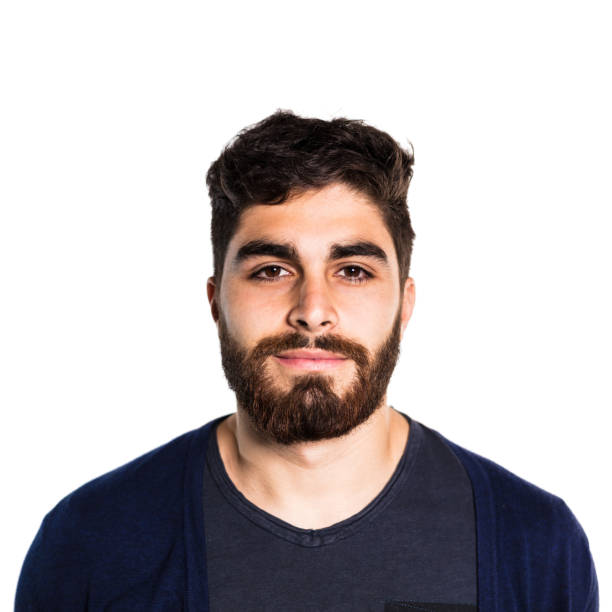 Portrait of handsome young man with beard. Close-up of smiling male against white background. He is wearing casuals.