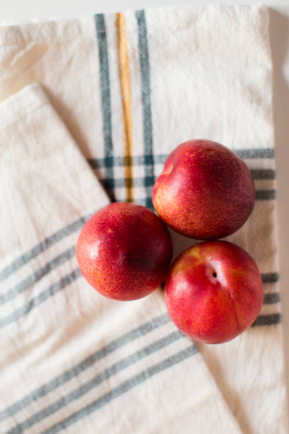 istock Red Plums on Plaid Towel 1062525046
