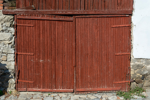 Old closed wooden door with wooden wall