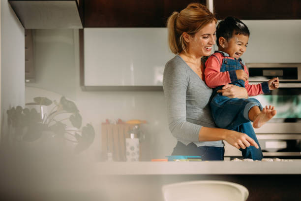 istock Mother and son enjoying while baking cookies in kitchen 1062535616
