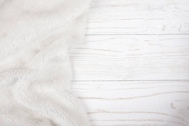 istock White fur on a worn white wooden background 1062539372
