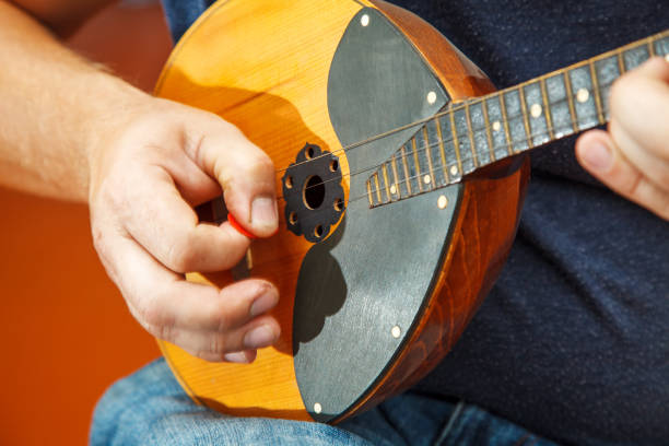 man playing the mandolin. hands closeup