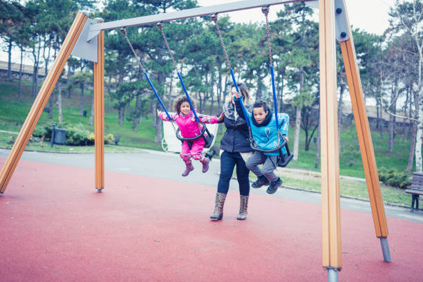 istock Mixed race children playing with mother in public park 1062543866