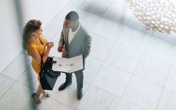 istock Partners revieving a business document in lobby 1062544036
