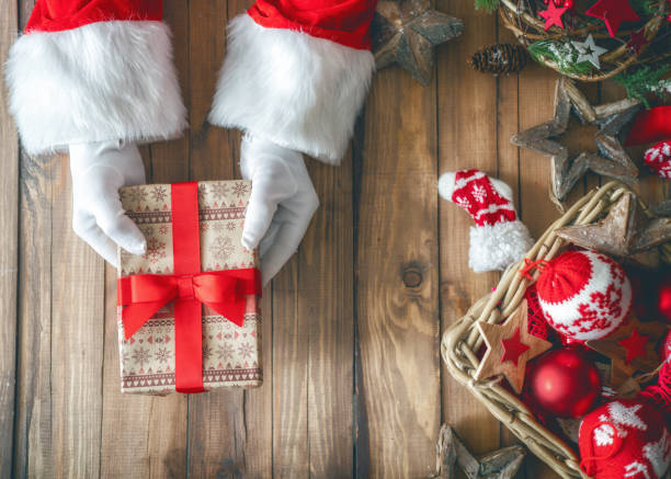 istock Hands of Santa with present 1062545922