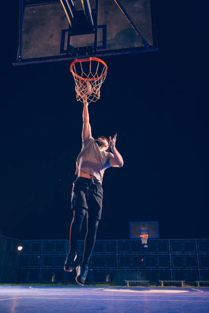 istock Young bearded men playing basketball outdoors 1062546598