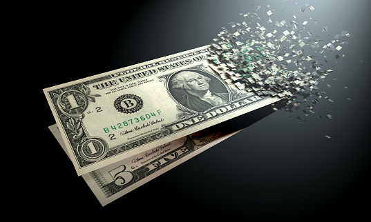 La desmaterialización del dinero, dinero es desmaterializada en un fondo negro. photo