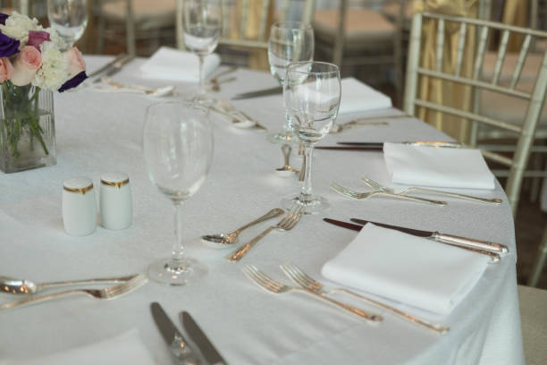 istock Elegantly lit holiday dinner table with wine glasses 1062549496