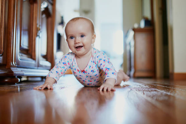 istock Baby girl learning to crawl 1062557342