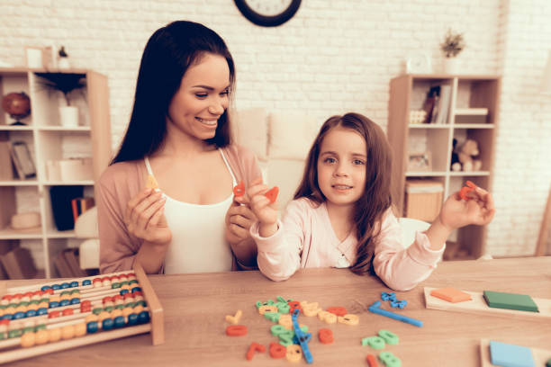 istock Happy Mother and Daughter Learn Alphabet at Home. 1062557454