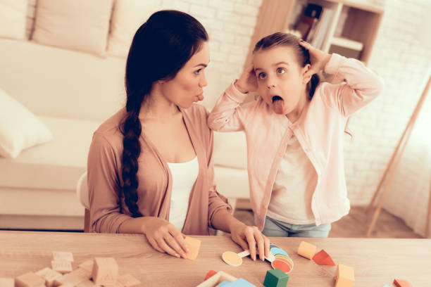 istock Happy Mom and Daughter Play and Make Grimaces. 1062557524