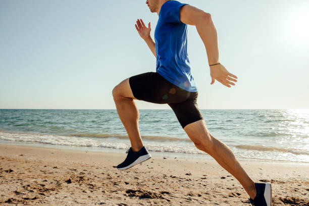 istock men runner summer run along sandy coast in sun 1062560146