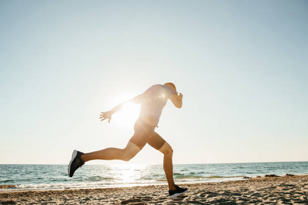 istock finish running athlete runner on sea beach in sunlight 1062560188