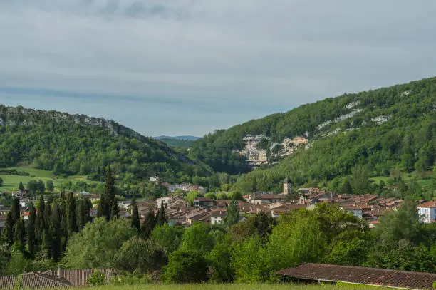 View towards ancient town in Ariege, France, with blue sky and mountains in background