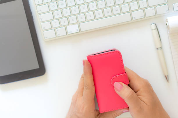 istock She holds a pink covered smartphone 1062560642