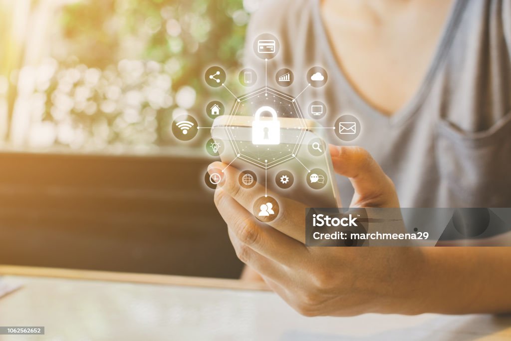 Woman using smartphone with icon graphic cyber security network of connected devices and personal data information Smart Phone Stock Photo
