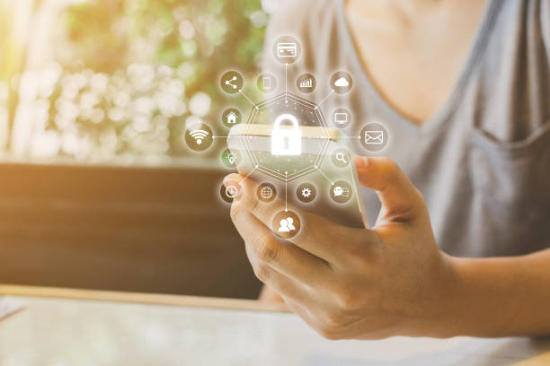 Woman using smartphone with icon graphic cyber security network of connected devices and personal data information Woman using smartphone with icon graphic cyber security network of connected devices and personal data information shielding photos stock pictures, royalty-free photos & images