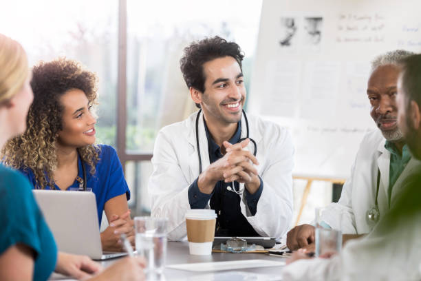 istock Cheerful doctor leading staff meeting 1062564248