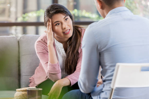 istock Distraught woman seeks help through counseling 1062564558