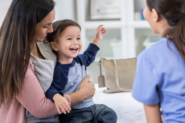 istock Cheerful toddler boy smiles at pediatrician 1062564764