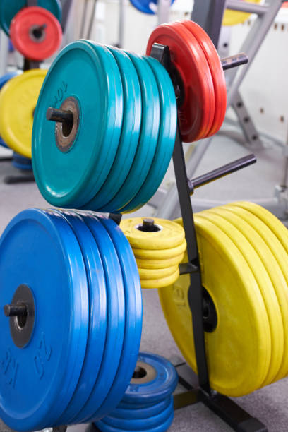 istock Multiple multicolored Barbells on stand in gym 1062569718