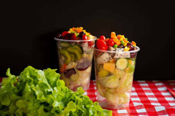 istock Fruit and vegetable salad in glass bowl on table with back background 1062572766