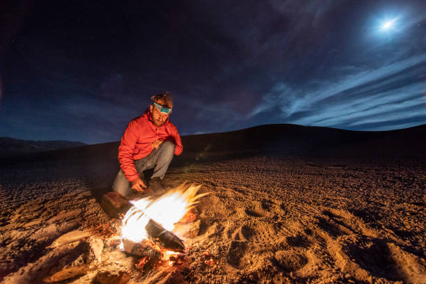 While looking for meteorites at Atacama Desert we made a stop for sleeping in the middle of the amazing Atacama Desert. One man on a camp fire under the full moon light on a starry night. Chile
