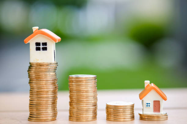 istock Different of size of house and stack coins. 1062575276