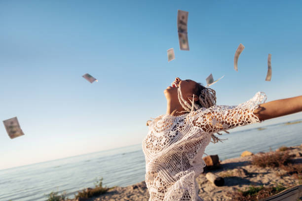 Successful prosperous freelancer throwing her money in the air Money in air. Successful prosperous freelancer with white dreadlocks throwing her money in the air prosperity stock pictures, royalty-free photos & images