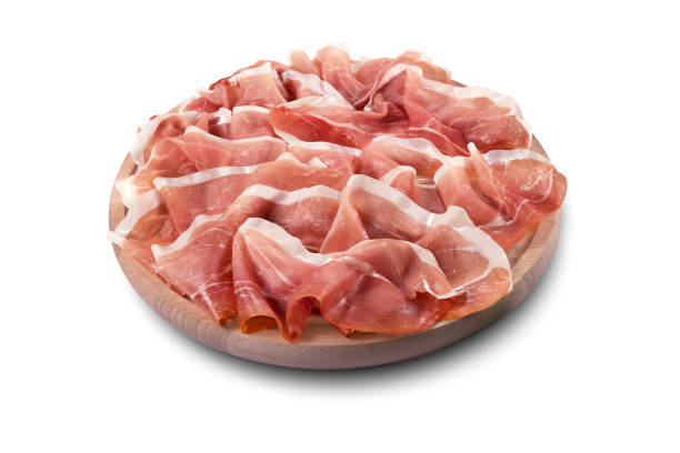 Round chopping board with sliced Parma ham Round chopping board with sliced Parma ham isolated on white background prosciutto stock pictures, royalty-free photos & images