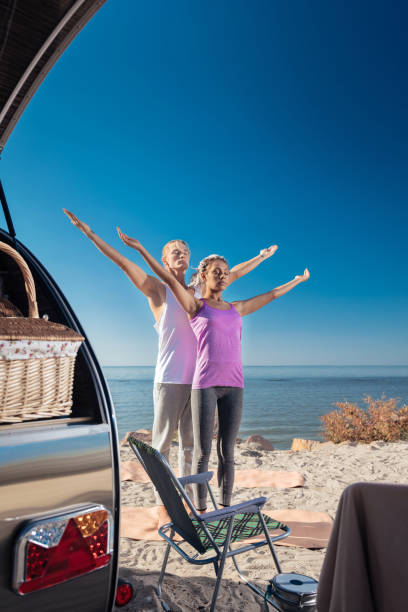 istock Couple spending weekends in compact trailer doing morning exercises 1062576552